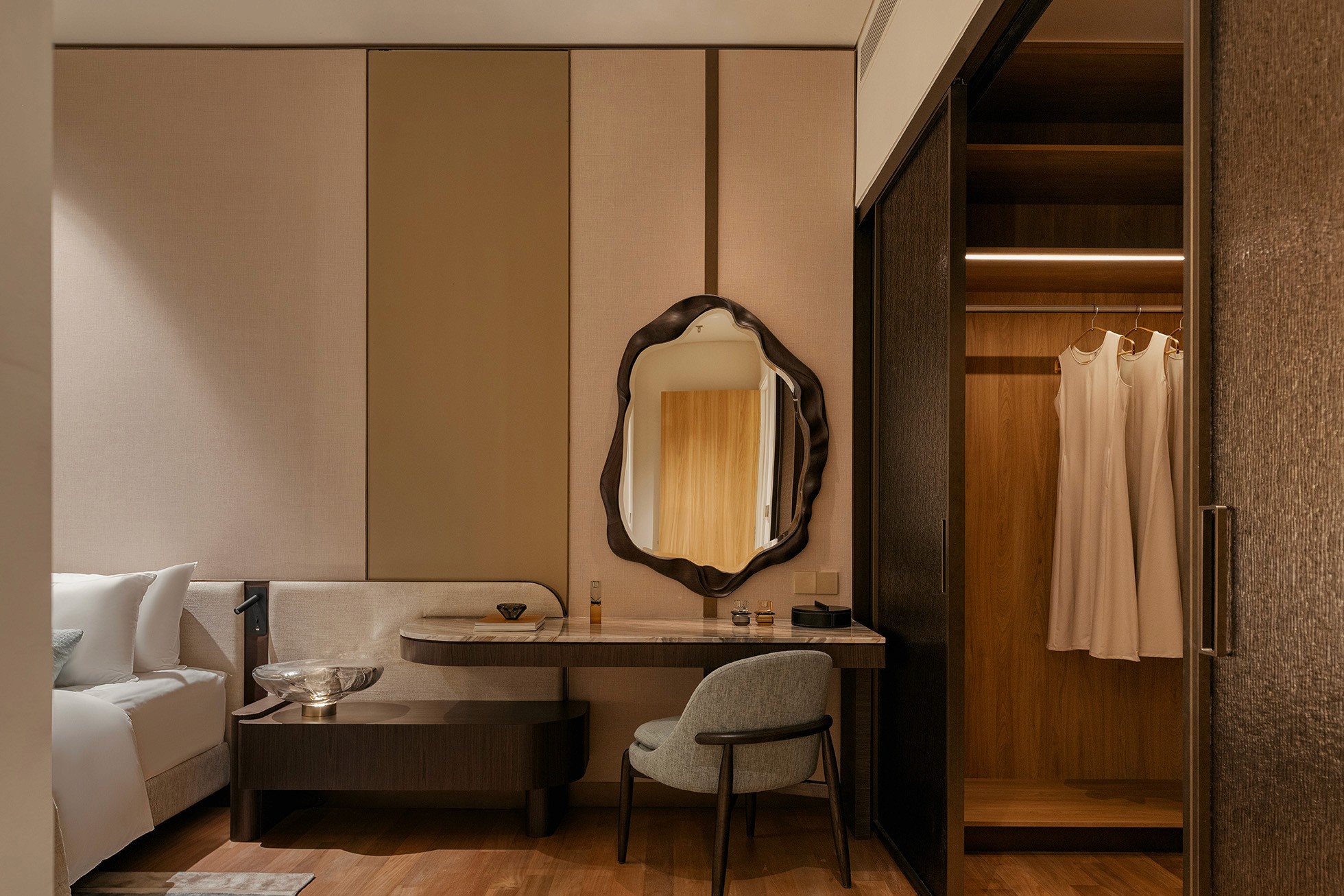 Dressing area with vanity, sculpted mirror and walk-in wardrobe — The Westin Residences show unit