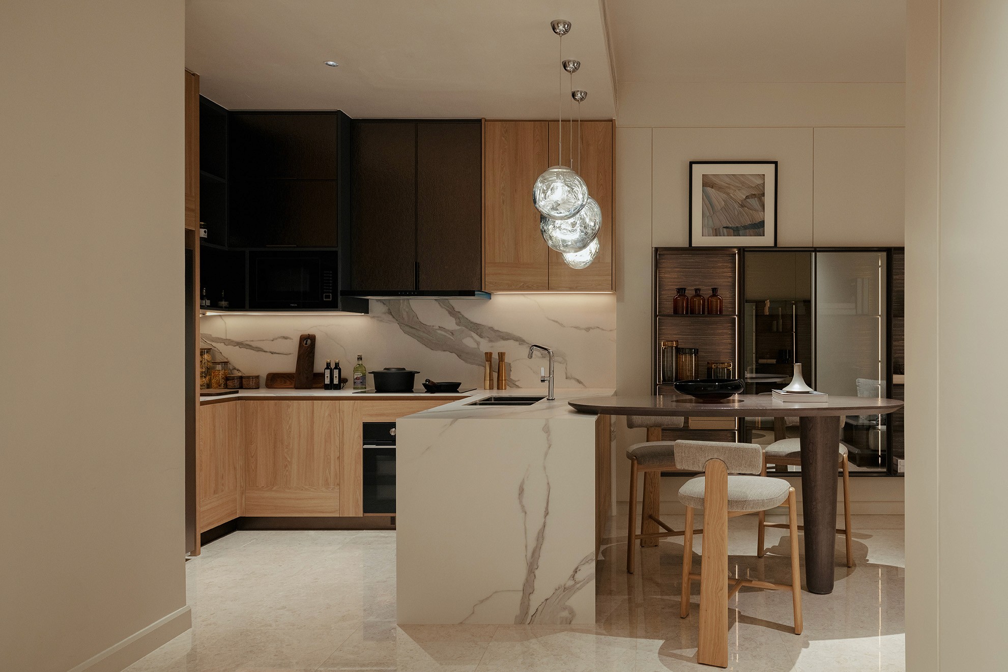 Kitchen with marble island, breakfast bar and timber cabinetry — The Westin Residences show unit
