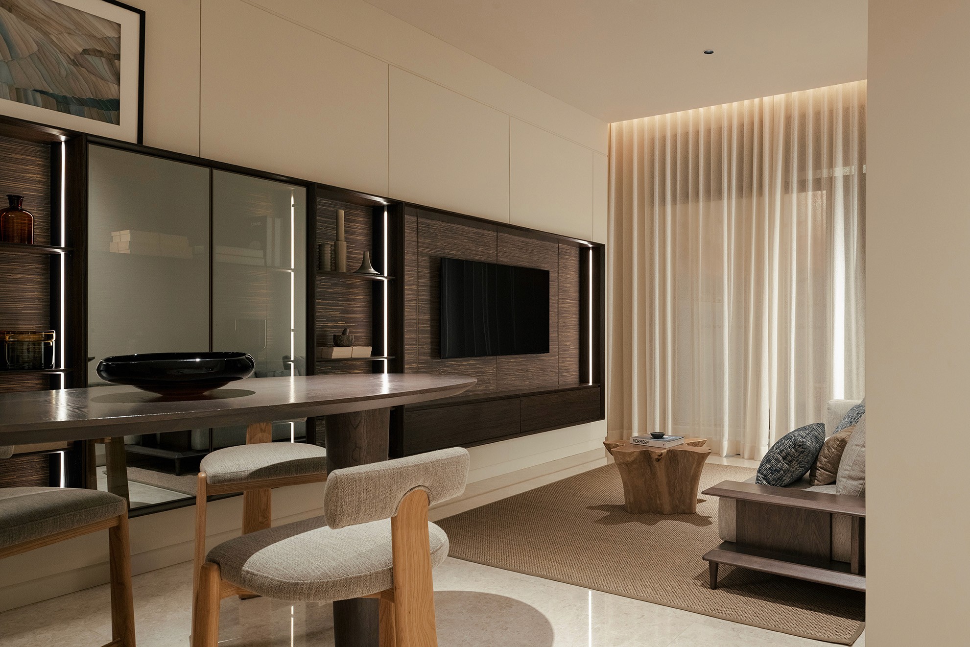 Living area with feature media wall and sheer-draped seafront windows — The Westin Residences show unit