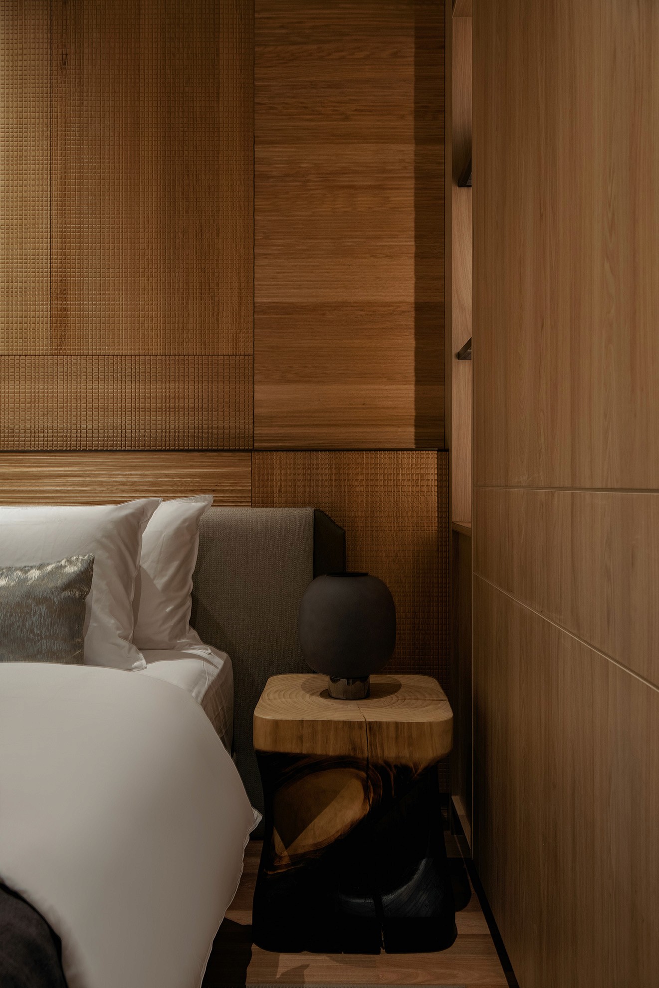 Master bedroom with upholstered headboard and timber-clad walls — The Westin Residences show unit